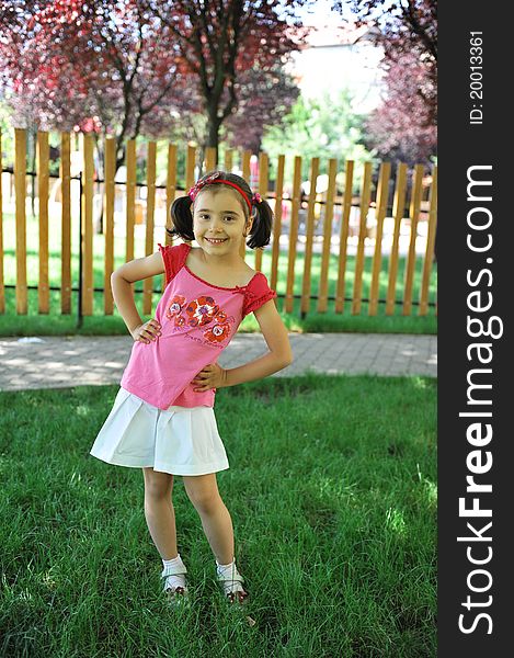 Cute little girl does outdoor fashion photo shoot