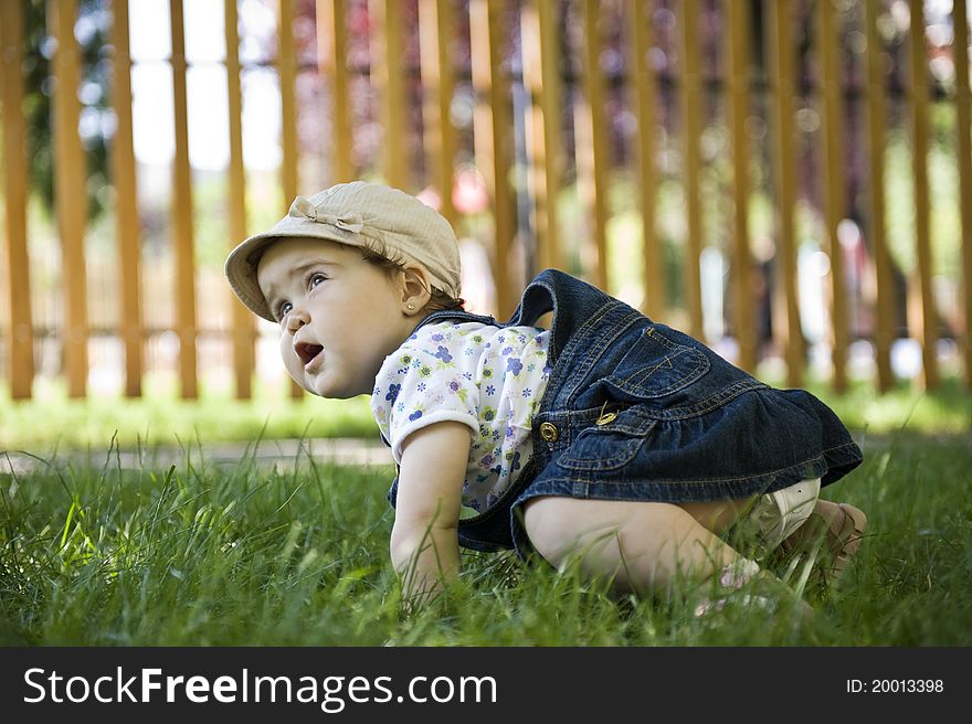 Adorable baby girl outdoors in the grass