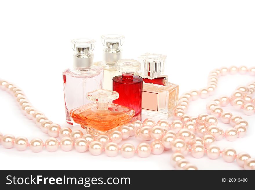 Perfume bottles and necklce isolated on white backgrond.
