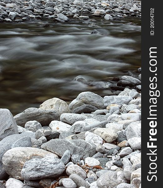 Beautiful wild river in the mountains covered with stones