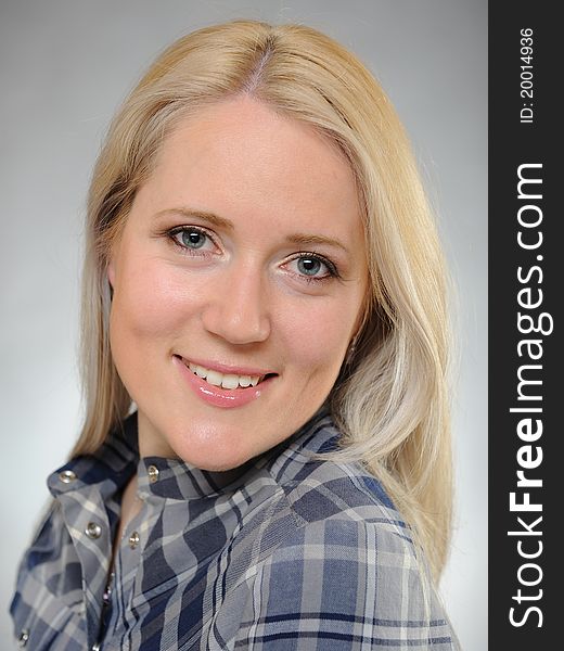 Portrait of young pretty smiling woman in a shirt