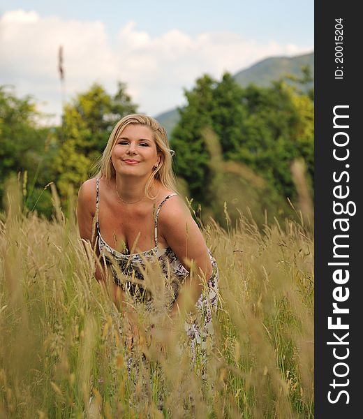 Pretty summer woman on field