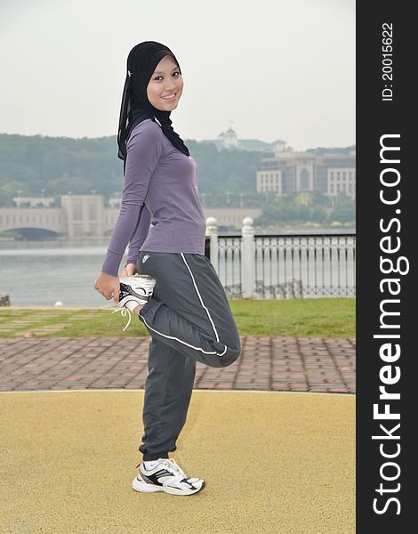 Young woman doing outdoor exercises. Young woman doing outdoor exercises