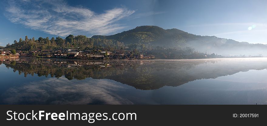 View of one village is located close to a lake also has mountain on background. View of one village is located close to a lake also has mountain on background.