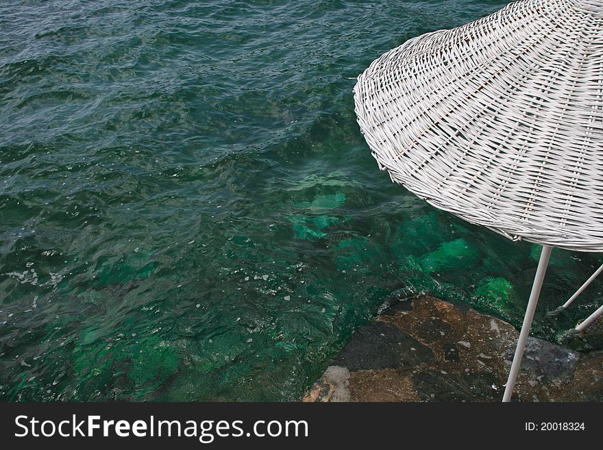 Umbrella On Beach With Sea Below