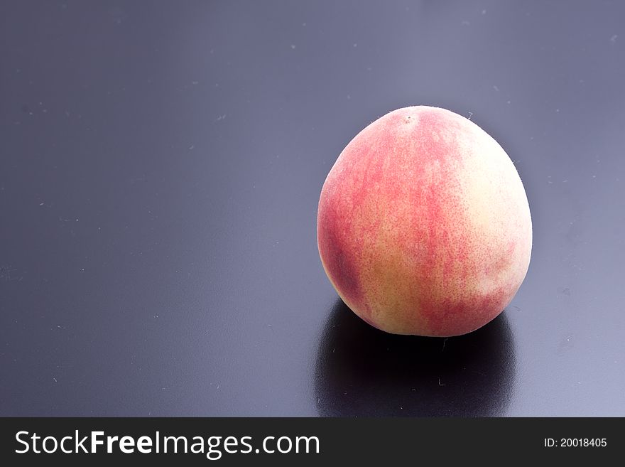 A peach on black backgrounds