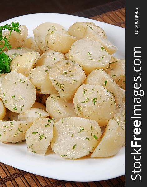 Boiled potatoes with dill and parsley. Closeup