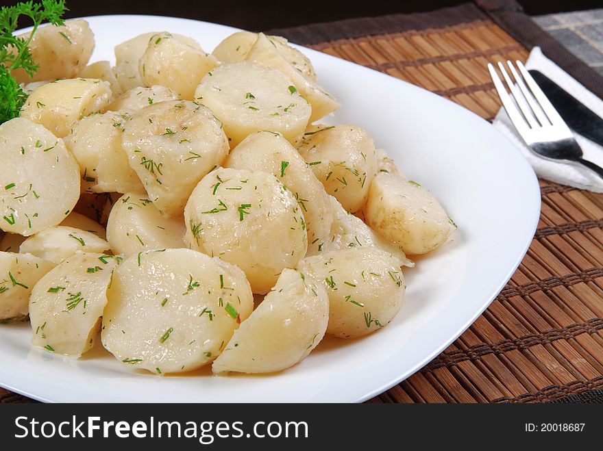 Boiled potatoes with dill and parsley