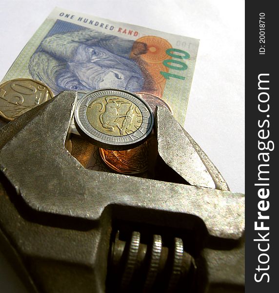 A five rand coin held in a vice grip. Symblising a tight cash flow.