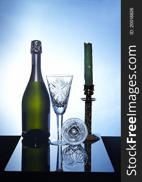 Still life with champagne bottle,glasses and canderstick