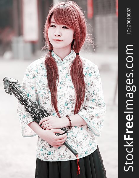 Charming Asian beauty holding the umbrella outdoor portrait. Charming Asian beauty holding the umbrella outdoor portrait