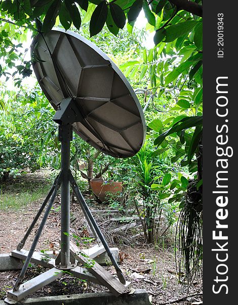 A satellite dish next to the house.