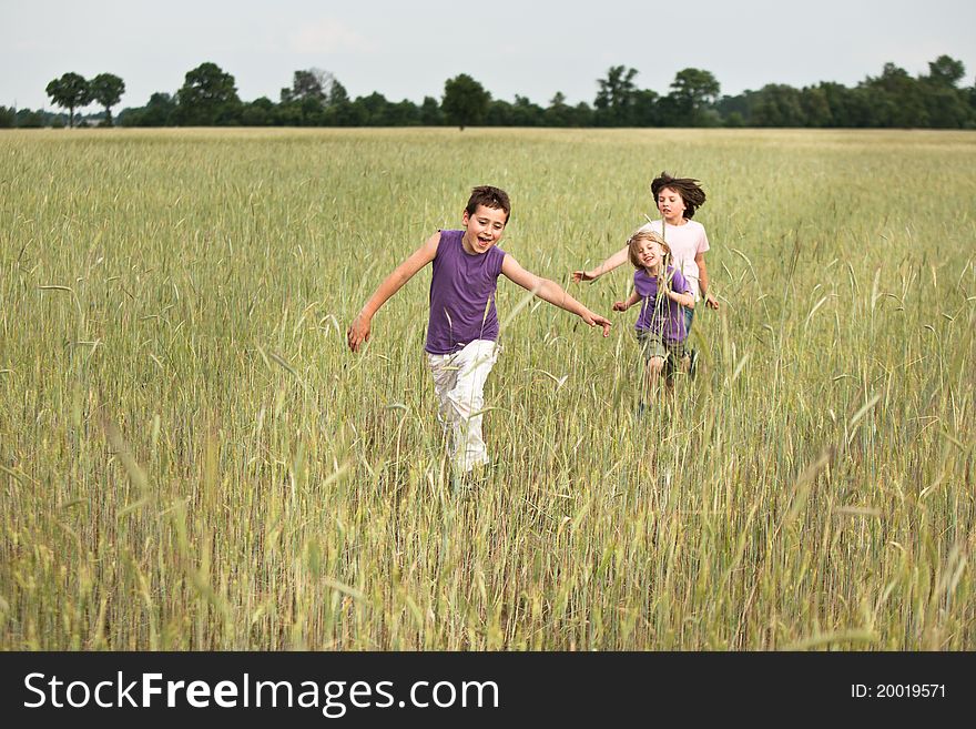 Tree boy running through a fields. Tree boy running through a fields