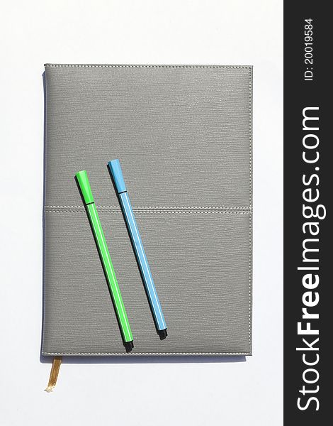 Gray notebook and pen, 2 pcs white background.