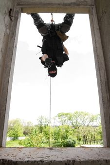 Soldier In Black Mask Hanging On Rope With Pistol Stock Photos