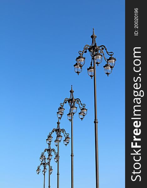 A number of city lights against the blue clear sky. A number of city lights against the blue clear sky.