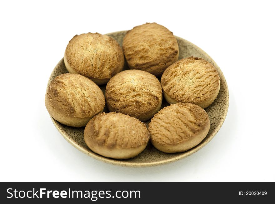 A Saucer with Seven Cookies on it on the White Background