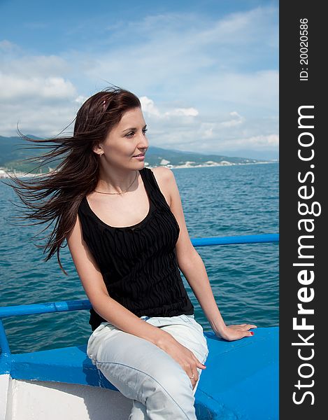 A beautiful young woman on a yacht at sea