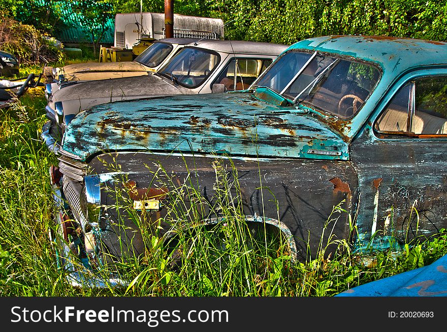 A few old cars rusting under the influence of time. A few old cars rusting under the influence of time