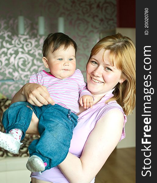 Young women with a little child at home. Shallow DOF, focus on baby