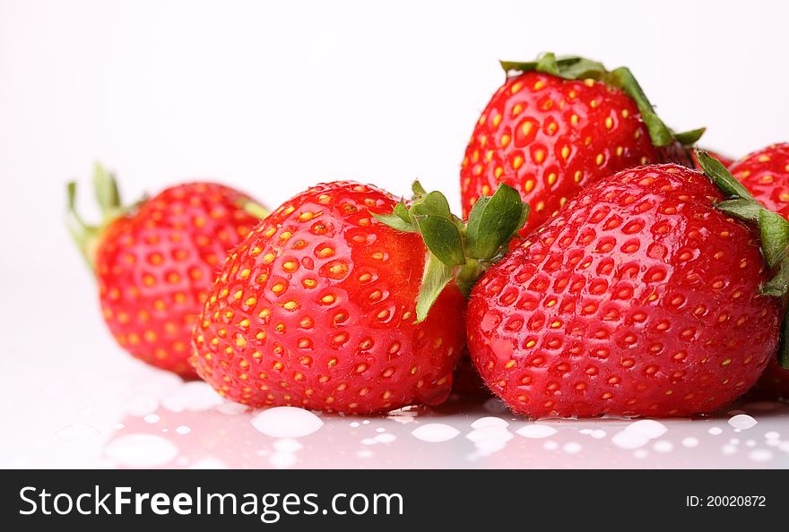 Close up strawberry on wet surface and isolated background