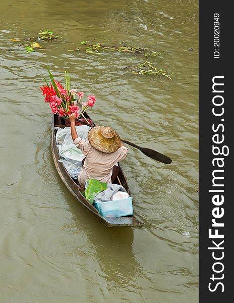 Lady selling flower from her boat