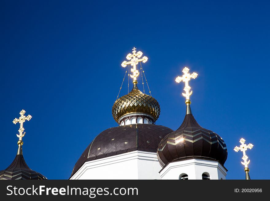 The crosses which are on domes of orthodox church, shone during a sunset (church of Transformations dominical in Belarus, the city of Smorgon). The crosses which are on domes of orthodox church, shone during a sunset (church of Transformations dominical in Belarus, the city of Smorgon)