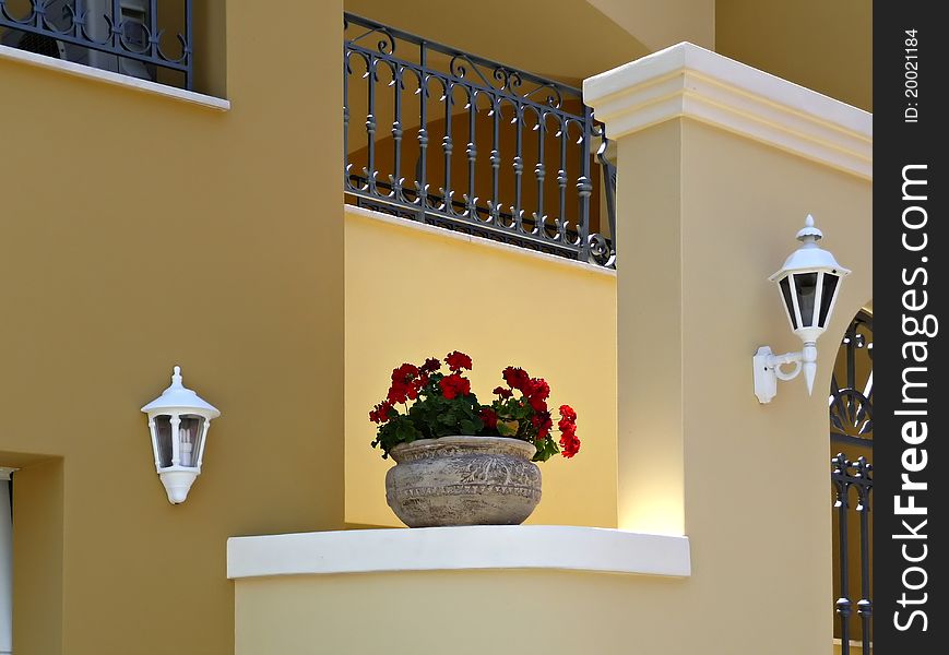 Traditional greek house with geranium in pot at main entrance. Traditional greek house with geranium in pot at main entrance.