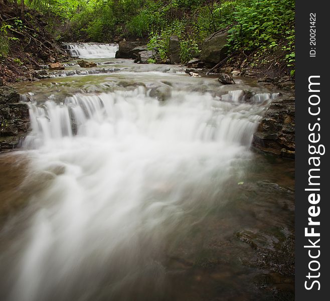 Small waterfall running through forest