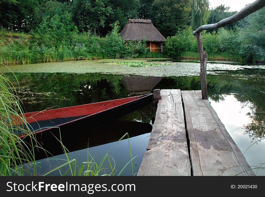 The house in forest on the brink of lake