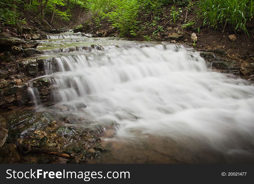 Small waterfall running through forest