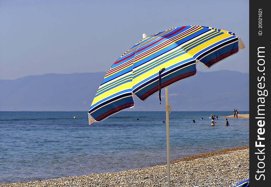 Colorfull beach umbrella at sunny summer day.