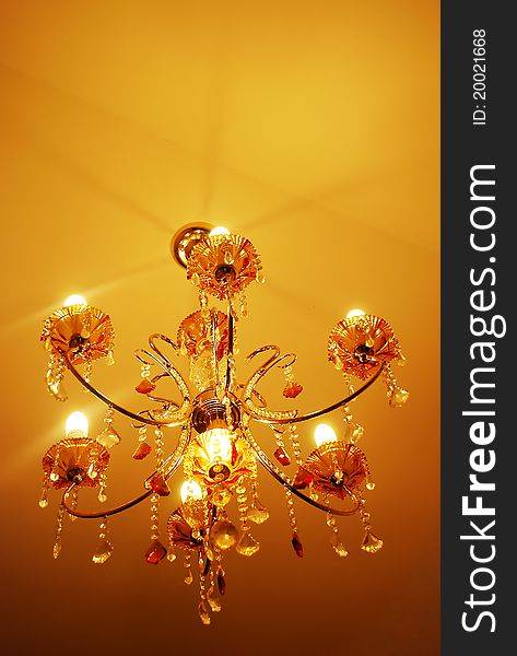 Yellow light chandelier hanging from ceiling