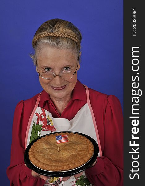 Senior grandmother offering a fresh apple pie. Senior grandmother offering a fresh apple pie