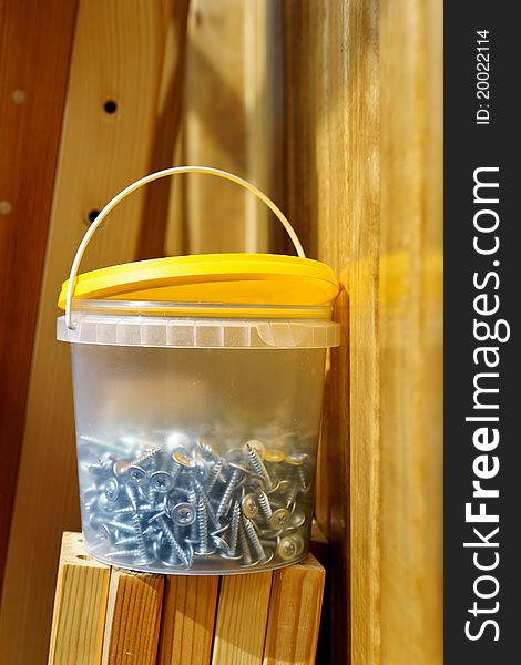 Self-tapping screws located in the plastic container, and the sawed paneling from a pine. Self-tapping screws located in the plastic container, and the sawed paneling from a pine.