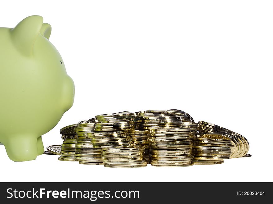 Green piggy bank standing next to a pile of golden coins on a white background. Add your text to the background. Green piggy bank standing next to a pile of golden coins on a white background. Add your text to the background.