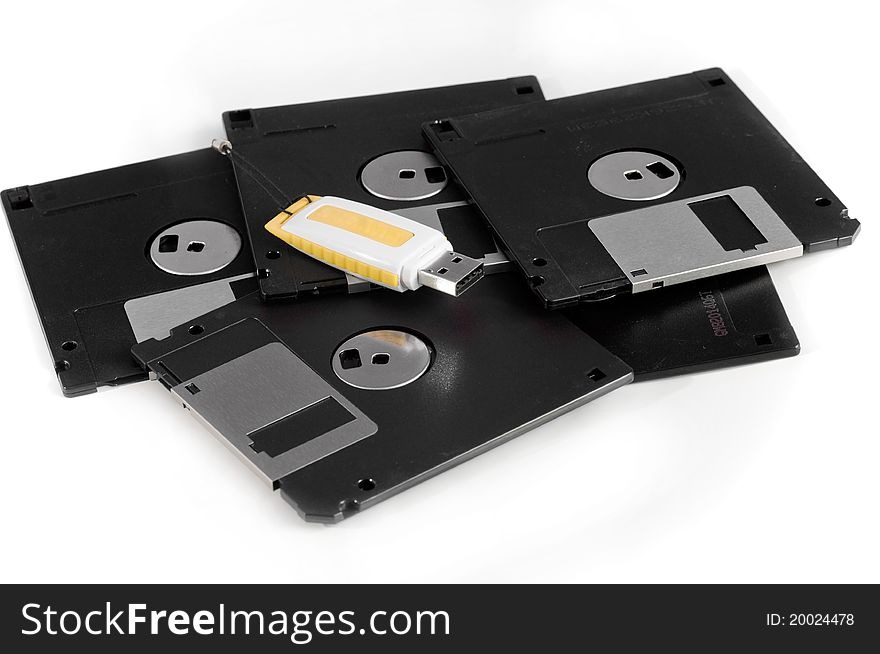 This image USB drive and floppy disk spiral on a white background. This image USB drive and floppy disk spiral on a white background