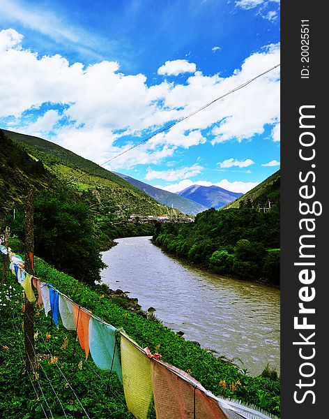 Harmony Western Sichuan Plateau,China  connect religious prayer flags with natural sky, river and hills.