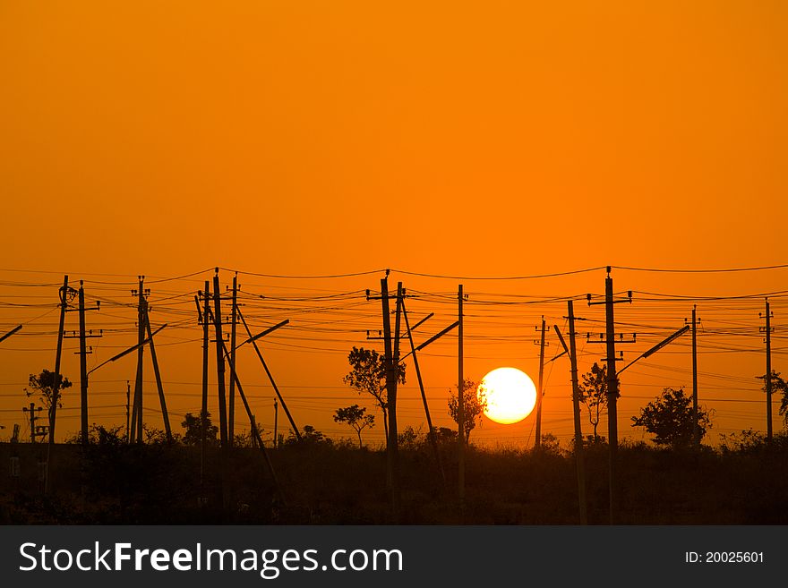 Sunrise from a electrical poles showing less trees and more poles. Sunrise from a electrical poles showing less trees and more poles