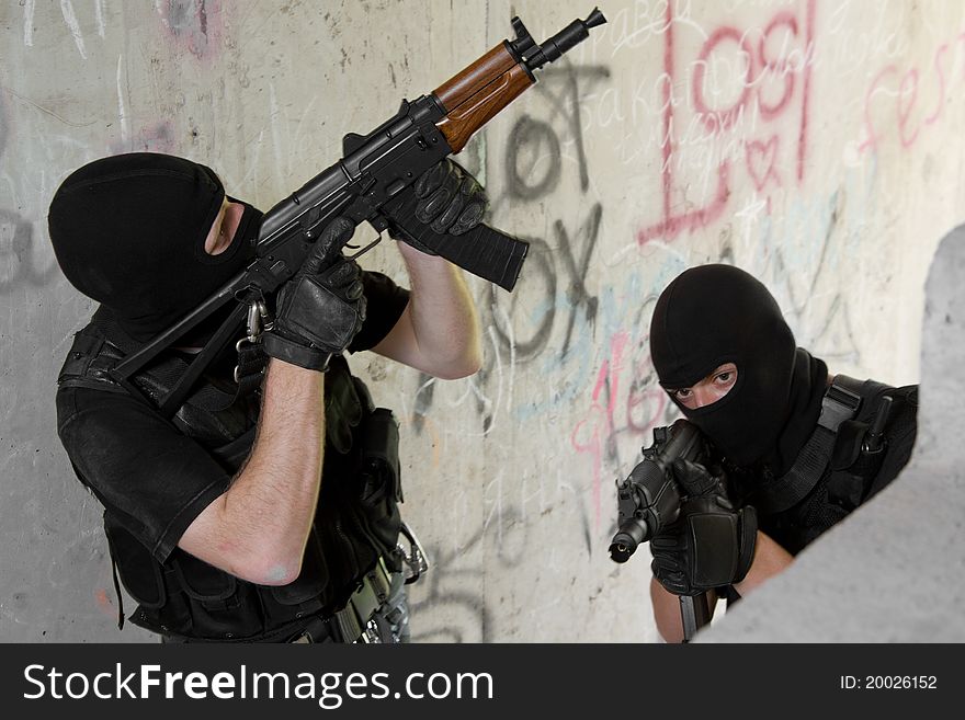 Soldiers In Black Masks Moving Upstairs With Guns