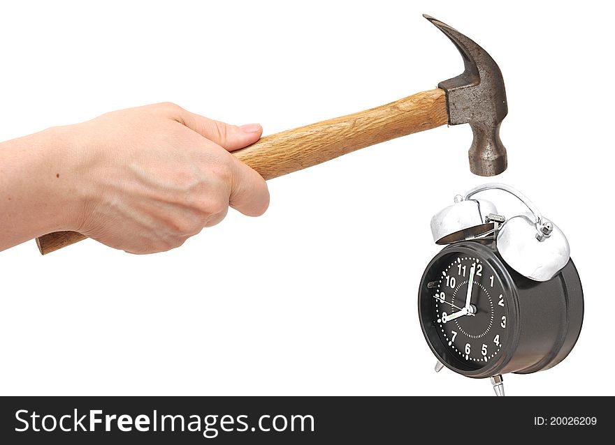 Hand holding a hammer about to hit the alarm clock