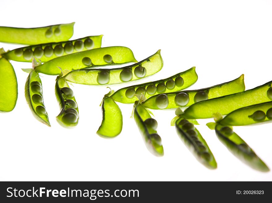 Open green pea pods isolated on a white background.