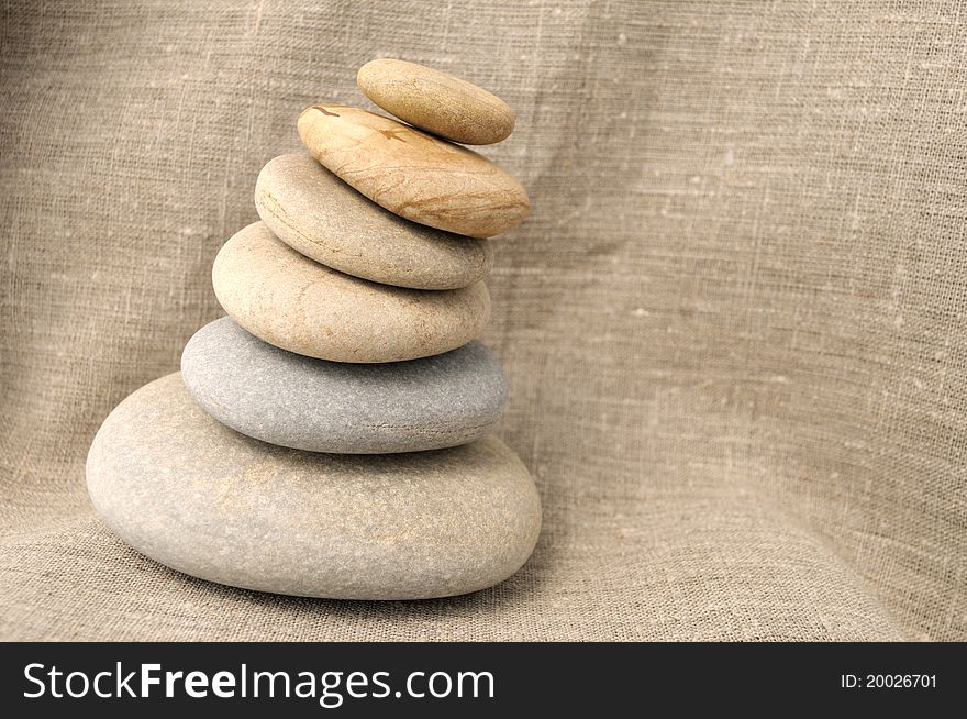 Pile of stones on a background of rough cloth