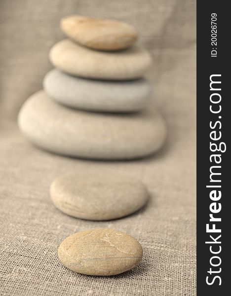 Pile of stones on a background of rough cloth