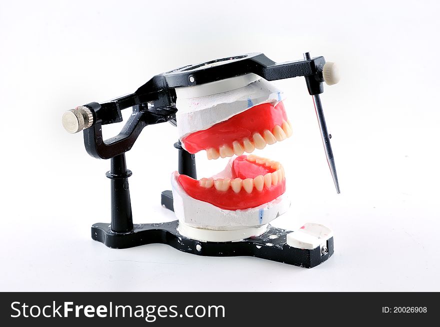 Dentures are attached to a special machine to work. Dentures are attached to a special machine to work