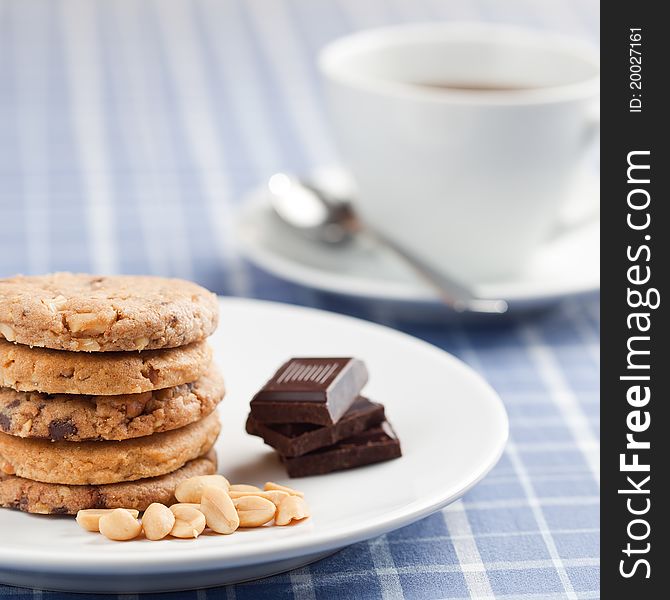 Peanut cookies with chocolate and cup of coffee or tea.