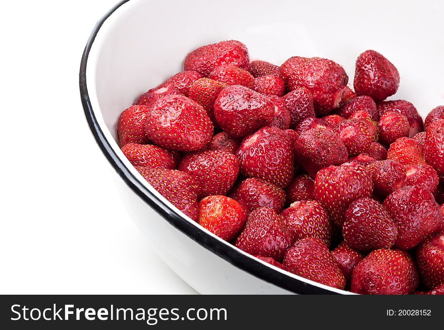 Clean strawberries in white bowl isolated on a background