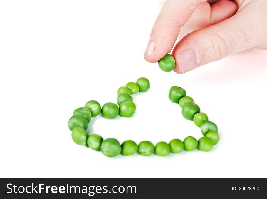 Green peas like a heart isolated on a white background
