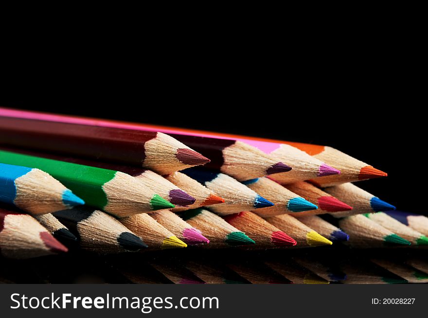 Many colors pencils isolated on a black background