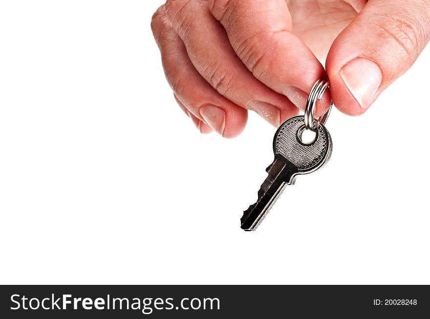 Three silver keys in a hand isolated on white background